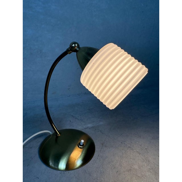 Well-preserved table lamp from the 1950s. Brass fixture. Opaline shade. E14 socket. Shade adjustable via wing nut. Can be...