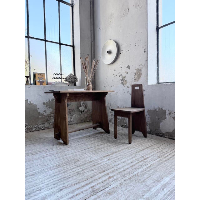 A set comprising a desk and a small chair in a brutalist style reminiscent of the 1950s. Made of solid pine, we love the...