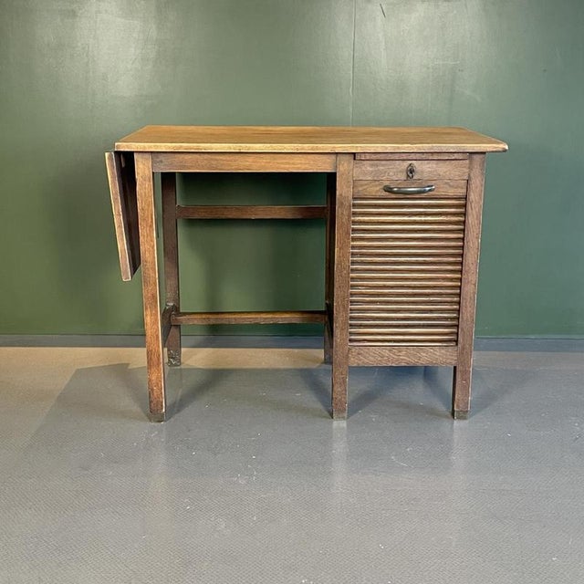 neat little single pedestal desk with extendable top and tambour fronted drawers. Approximate dimensions: height: 70cm...