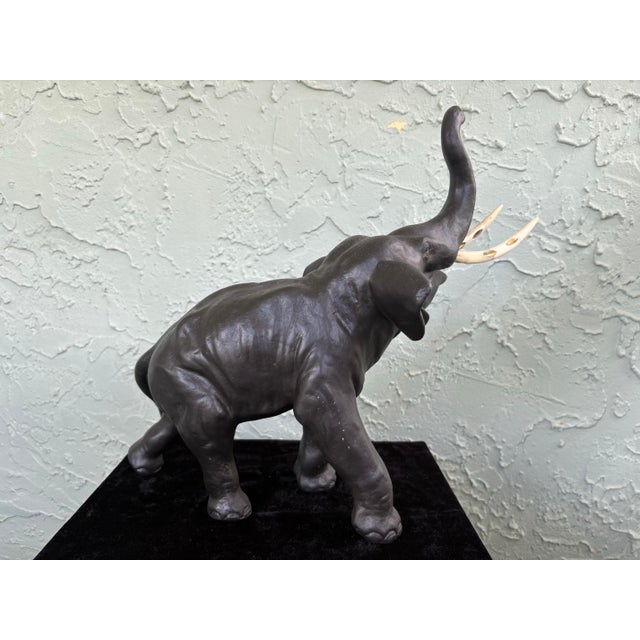 Striking antique elephant sculpture crafted in heavy cast iron with an original copper-plated (copper wash) finish, dating...
