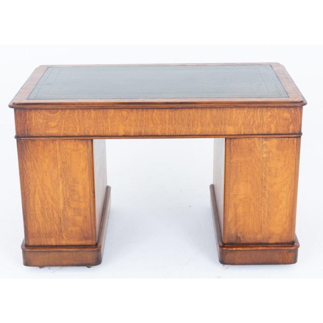 A distinguished Victorian oak pedestal desk of exceptional quality and generous proportions, presented in the desirable...