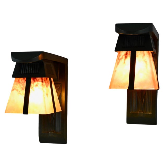 Pair of Art Deco sconces with stylized birds signed by Max Le Verrier. Original Daum Nancy glass shades. Patinated art...