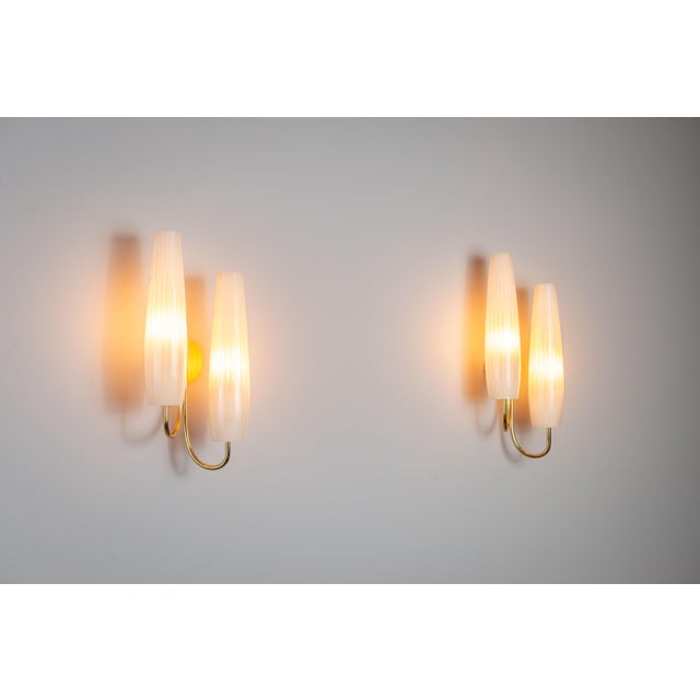 This pair of double-shaded sconces combines refined elegance with warm, atmospheric lighting. Each fixture features two...