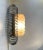 Unusual wall sconce with chrome plated perimeter of spiral steel and centershade in pressed glass. It resembles a bursting...