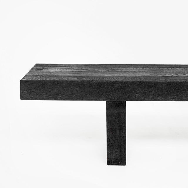 The Kurai Collection consists of a solid Padouk dining table, two benches and two stools finished with the Shou Sugi Ban...