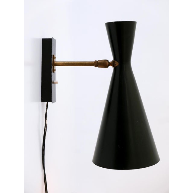 Rare, elegant and highly decorative mid-century modern sconce or wall lamp. Shade adjustable in various position due to...