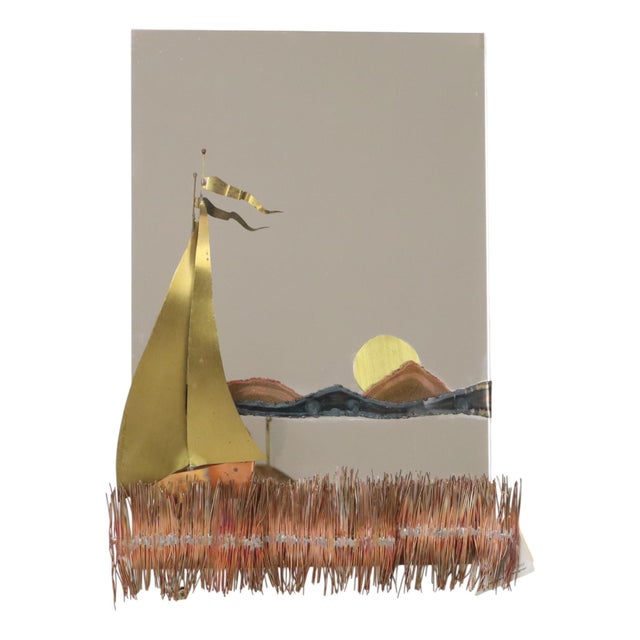 A stunning vintage mirror featuring a copper and brass sculpture of a sailboat, reeds in the foreground, and a setting sun...