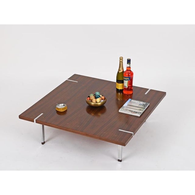 Gorgeous and unique large square coffee table in beautiful rosewood and chrome-plated metal. This stylish table was...