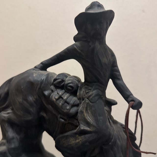this stunning western-themed ceramic statue. It features a cowboy holding a lasso astride a rearing horse, beautifully...