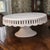 The "Crace's Teaware" White Porcelain Pedestal Cake Stand is a stylish and elegant addition to any dining table or special...