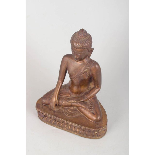 Bronze Buddha figure. Seated Buddha figure executed in patinated bronze with a classical meditative pose, detailed drapery...