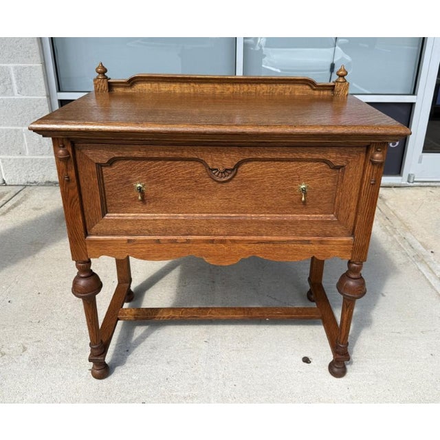 This antique oak server, crafted by J.B. Van Sciver Co. in Camden, NJ, features a beautifully figured top, turned legs,...