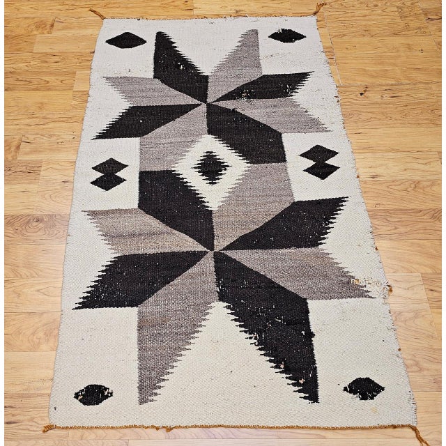 Embrace timeless character and cultural richness with this vintage Native American Navajo rug, handwoven in the mid-20th...