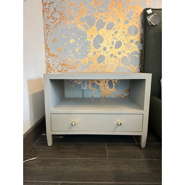 Made Goods Jarin Low Nightstand in light grey faux Belgian linen with brass hexagon knobs. Curated by Arden Home. Reg...