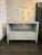 Made Goods Jarin Low Nightstand in light grey faux Belgian linen with brass hexagon knobs. Curated by Arden Home. Reg...