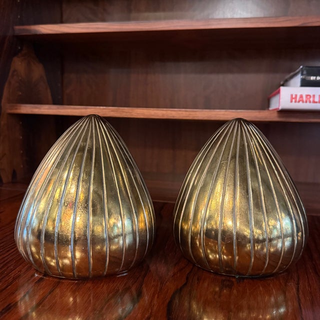 This pair of Mid-Century Modern brass plated teardrop shaped bookends are by Ben Seibel for Jenfred Ware. The bookends are...