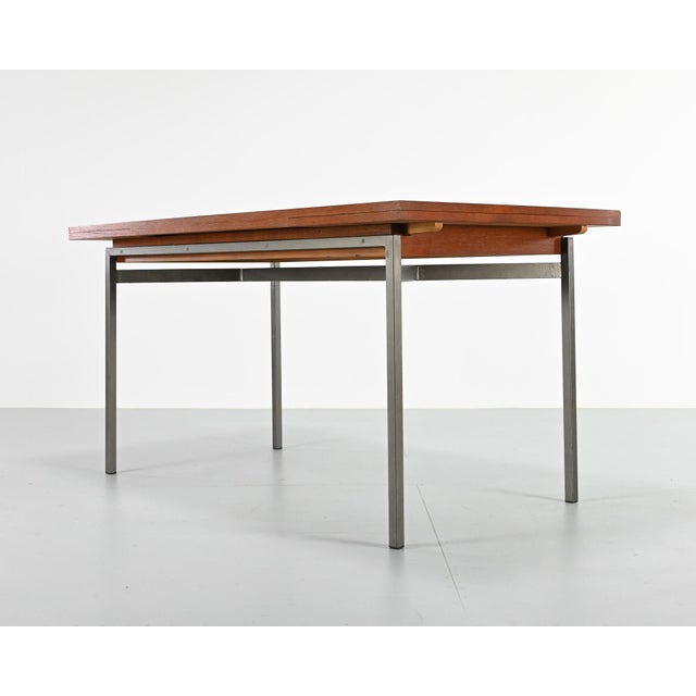 Vintage teak dining table, extendable to 208 cm. Steel base. Minor signs of wear, good overall condition. France, 1960s....