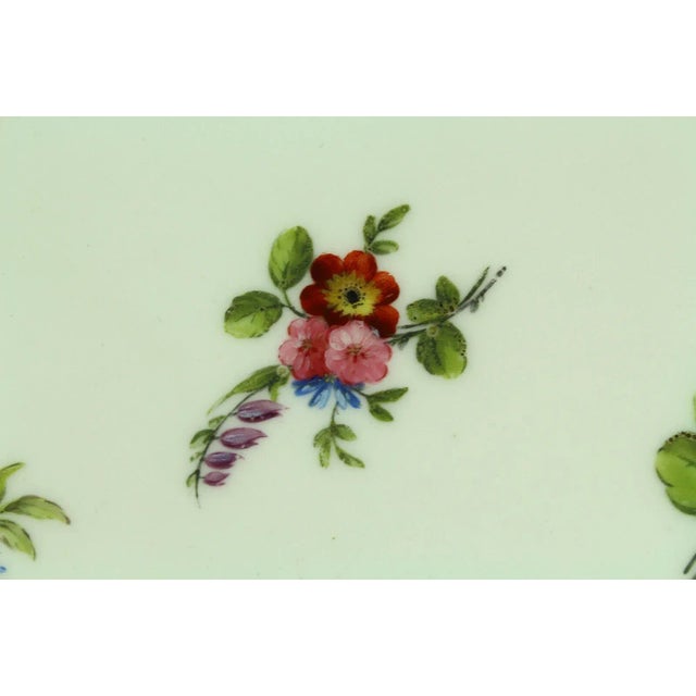 An outstanding antique soft paste porcelain plate by Sèvres of France All hand painted floral groupings up front,...