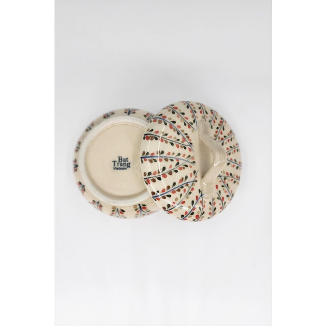 A beautifully crafted hand-painted lidded bowl from Bat Trang, Vietnam, celebrated for its centuries-old ceramic artistry....