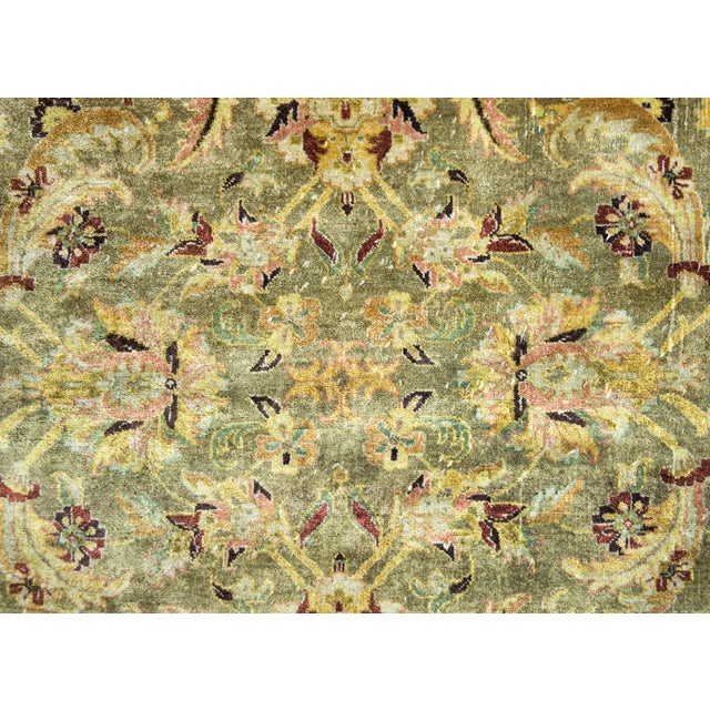 A wonderful late 20th century Indian Oushak rug with an all-over mirrored large-scale floral, leaf, and vine pattern...