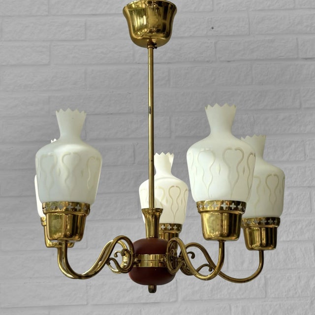 Scandinavian mid-century chandelier, produced by an unidentified Swedish manufacturer in the 1950s. Crafted from brass, it...