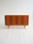 Northern European production, 1950s–1960s. Teak highboard with tapered legs, hinged doors, internal shelves, and a side...