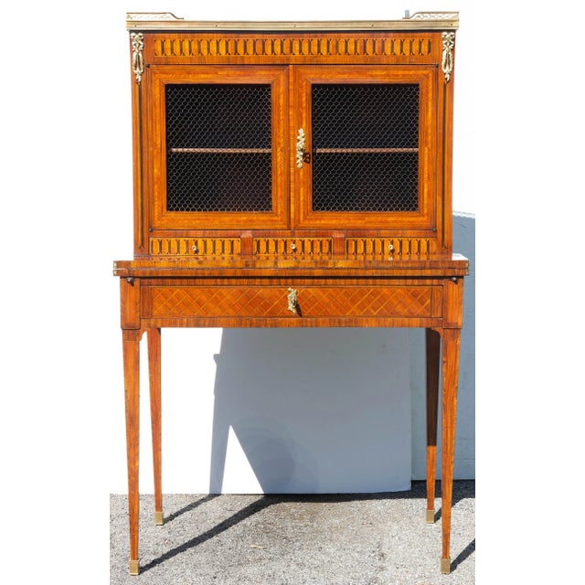 Antique Louis XVI style bonheur du jour desk. Fine kingwood parquetry inlay. Gilt bronze mounts. Figured marble top. Circa...