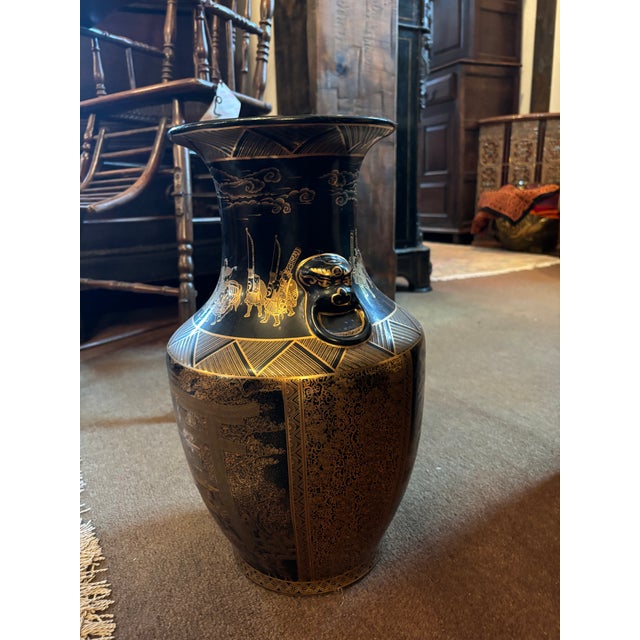 This is one ornate vase! The gold designs depict tranquil landscape scenery and a temple. There are also depictions of...