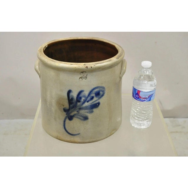 Antique Stoneware Two Gallon Crock with Cobalt Blue Slip Trailed Floral Design. Circa Mid 19th Century. Measurements: 9" H...
