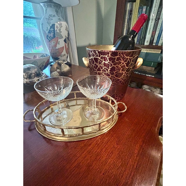 This is a vintage Italian art glass ice bucket featuring a dramatic oxblood red ground overlaid with an intricate (maybe...