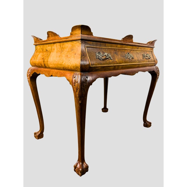 Beautiful Italian Burlwood Tea Table with one paper-lined drawer. Carved foliate shoulders with ornate brass hardware and...