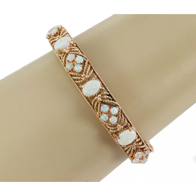 This gorgeous Estate bangle bracelet is crafted from 14k yellow gold with a textured finish. The back of the bangle has an...