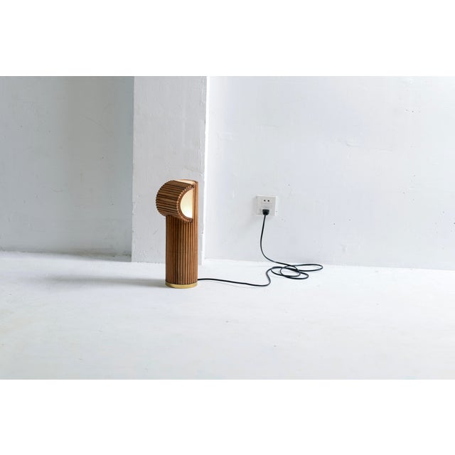 A stylish mid-century modern style rattan table lamp featuring natural organic rattan with a honey lacquered finish, that...