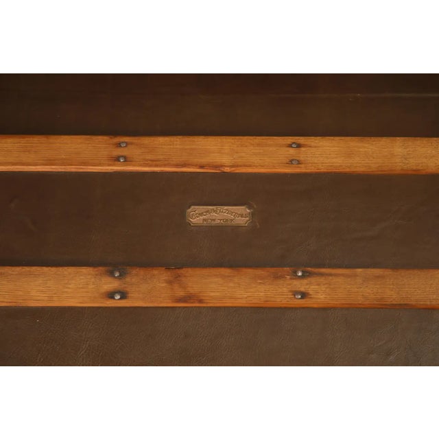 A beautifully restored flat-top steamer trunk by renowned New York luggage maker Crouch & Fitzgerald, featuring its...