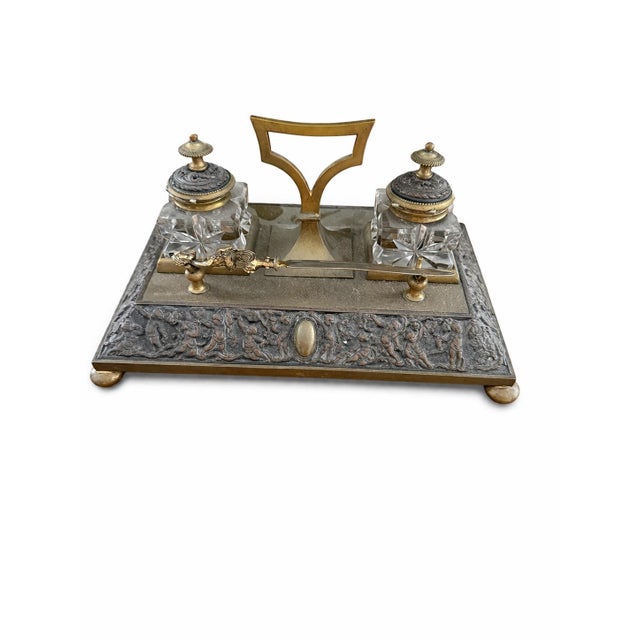 A striking and substantial antique double inkwell desk set, crafted in solid brass with exceptional weight and presence,...