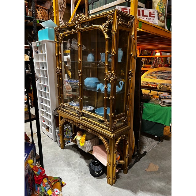 Up for consideration is a stunning vintage gilded gold ornate display cabinet with glass shelves. This is beautiful piece...