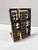 A sculptural vintage abacus bookend featuring a dark wood frame, sliding wooden beads, and handsome aged brass detailing....