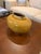 Aerin low, ceramic vase with gold trim on base and rim. Speckled finish transitioning from gold to amber. Hand made in Italy.