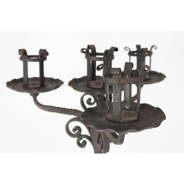 Beautiful wrought iron candelabra with 4 arms on 3 feet Intact and in excellent condition, there are some points of...