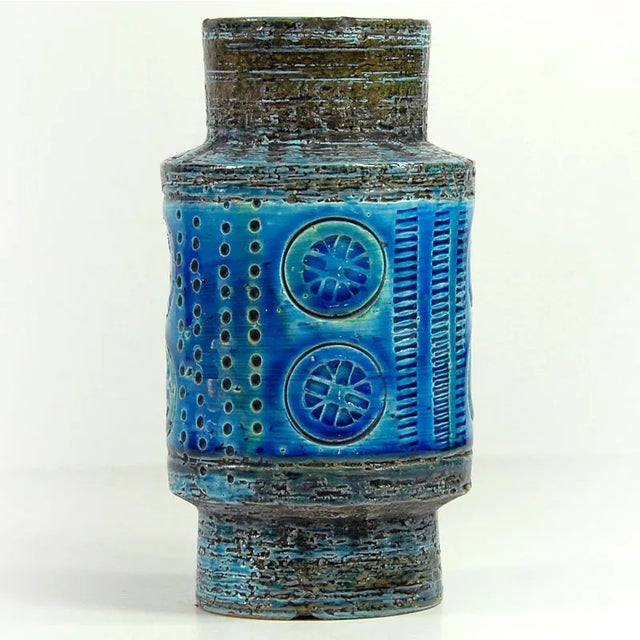 A small vase made of ceramics decorated with the sgraffito technique and glazed in colors called Rimini Blue. The vase was...