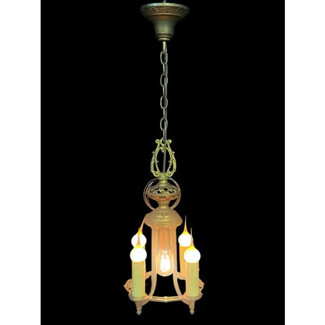 This distinctive chandelier boasts 4 candle style electrical lights and a central socket. It’s a historical piece that is...