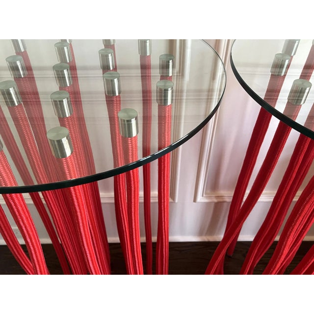 A pair of tall red ORG table designed by Fabio Novembre (Italian, born 1967) in 2001 for Cappellini. Made of glass top...