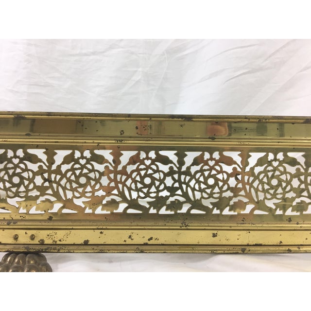 This brass fender has lovely lace-cut roses and thistles and unexpected lion's feet. Dates from ca. 1915. In good...