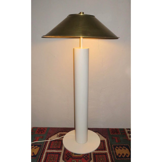 Peter Preller for Tecta elegant and unusual white lacquered metal floor lamp with a brass shade that rests on brass...