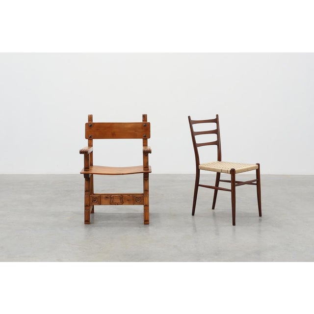 Dating back to circa 1900, this Spanish armchair tells a story of enduring Iberian craftsmanship and honest, timeless...