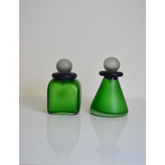 Elegant pair of Murano glass bottles. Each bottle has a label indicating "Made in Italy, Murano" In the style of Franco...