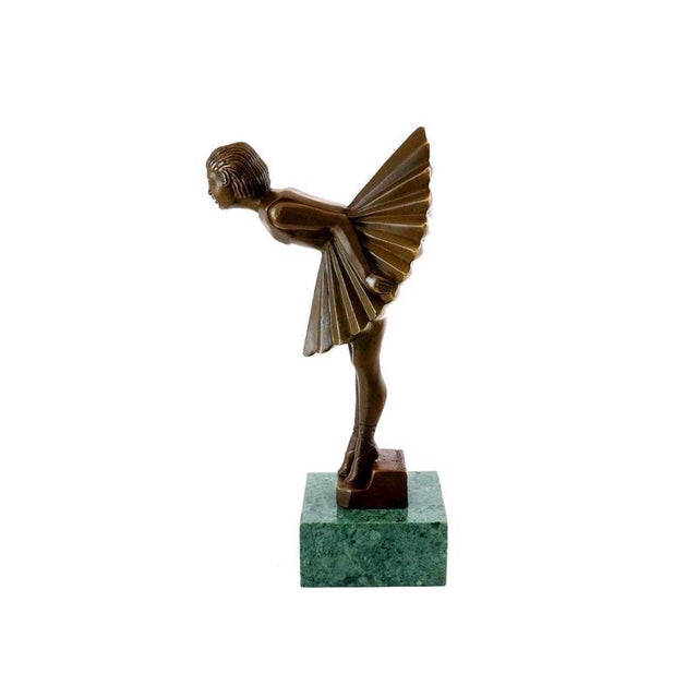 This bronze sculpture depicts a young ballerina in a horizontal pose. The piece reflects the influence of Russian ballet...