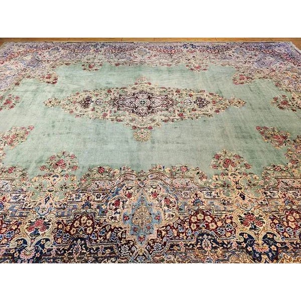 Discover the unparalleled elegance of this exquisite oversized vintage Persian Kerman rug, a truly rare find dating to the...