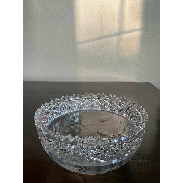 Stunning vintage cut crystal bowl featuring an intricate geometric starburst pattern and dramatic sawtooth rim. Richly...