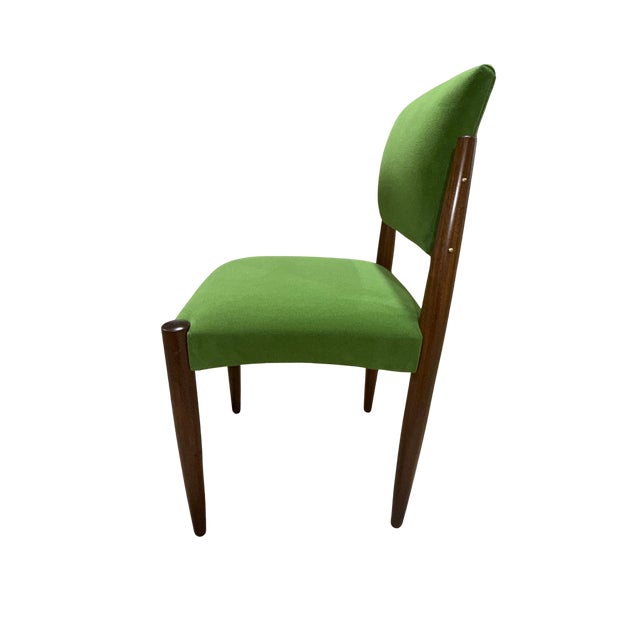 A striking set of six Italian Mid-Century Modern dining chairs, crafted in the 1960s with beautifully sculpted solid...